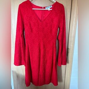Red dress with lace detail. Flowy sleeves.